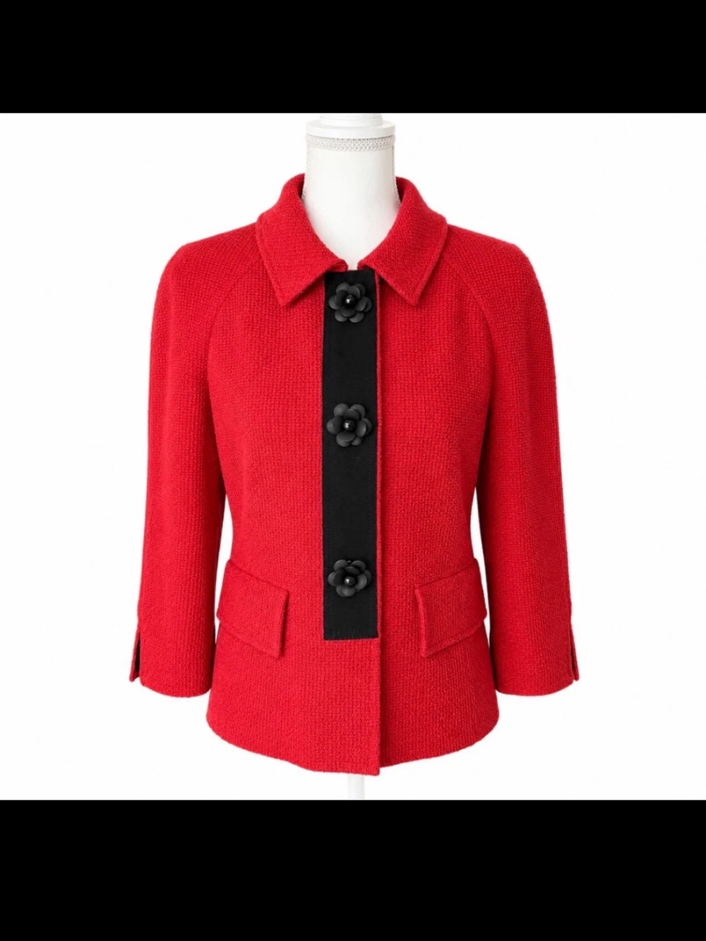 St John red knit jacket with black trim and flower buttons